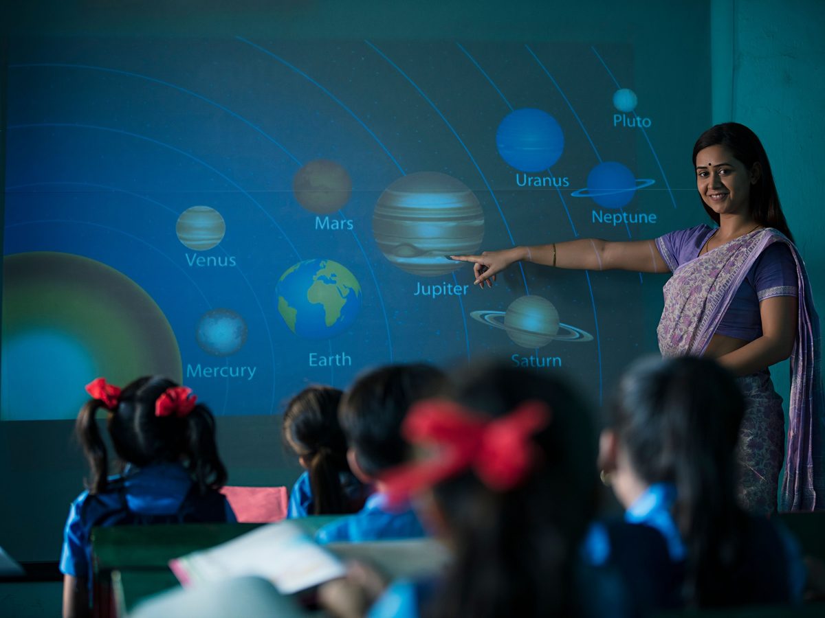 A teacher at a classroom smart screen during a lesson